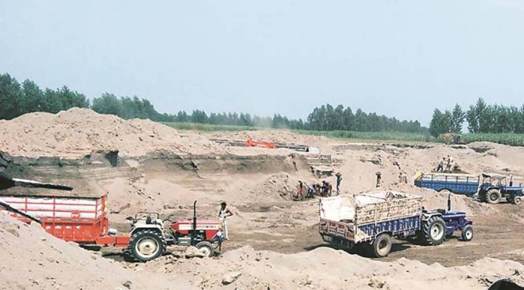 Sand being mined from a dry riverbed in Amritsar district