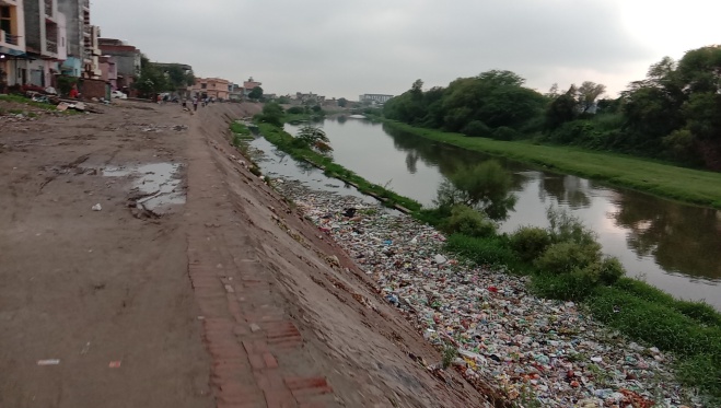 July 21, 2020 pic showing drain no. 6 (left) choked with solid waste, while drain no. 8 (right) flowing next to it. (Bhim Singh Rawat)